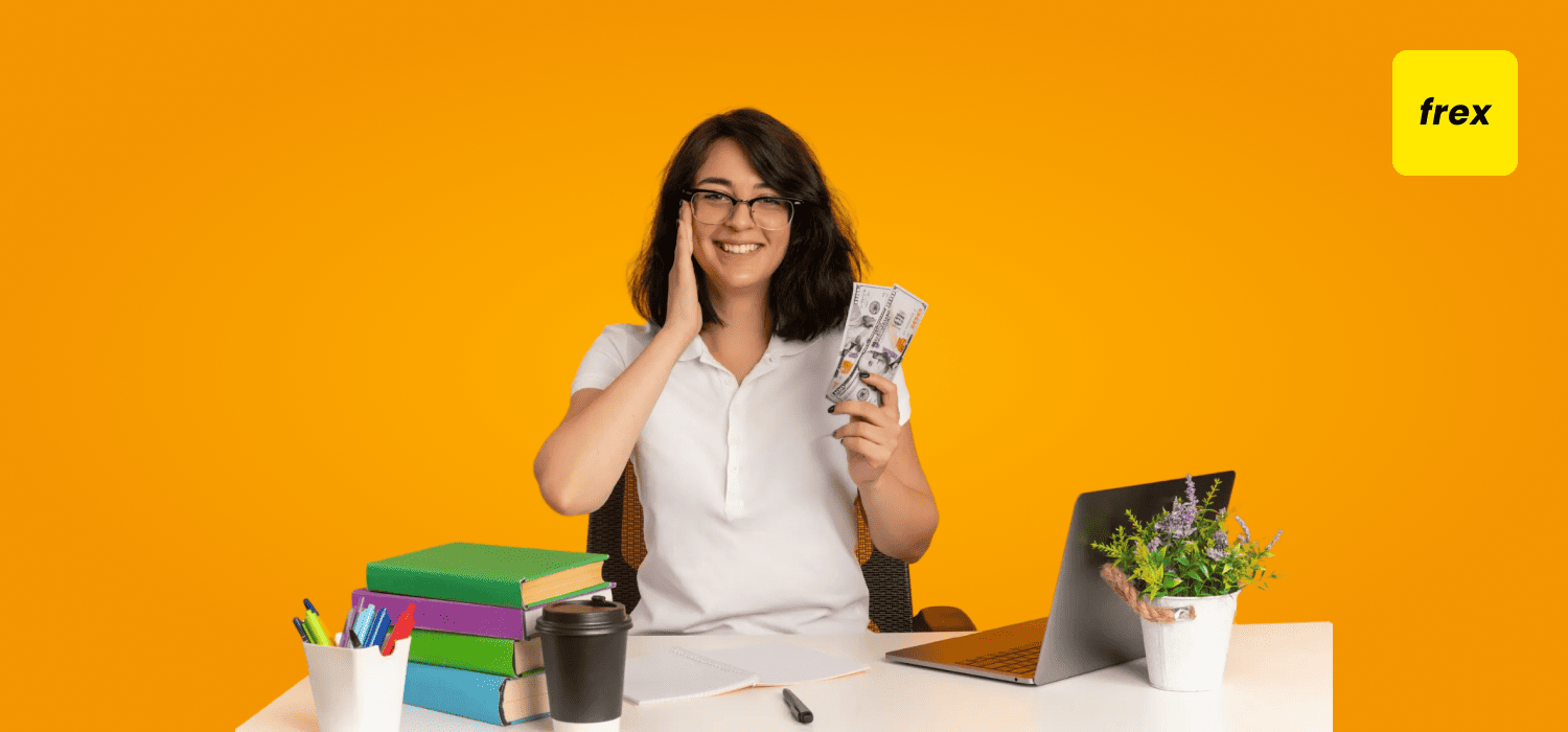 Happy girl smiling with hand full of cash