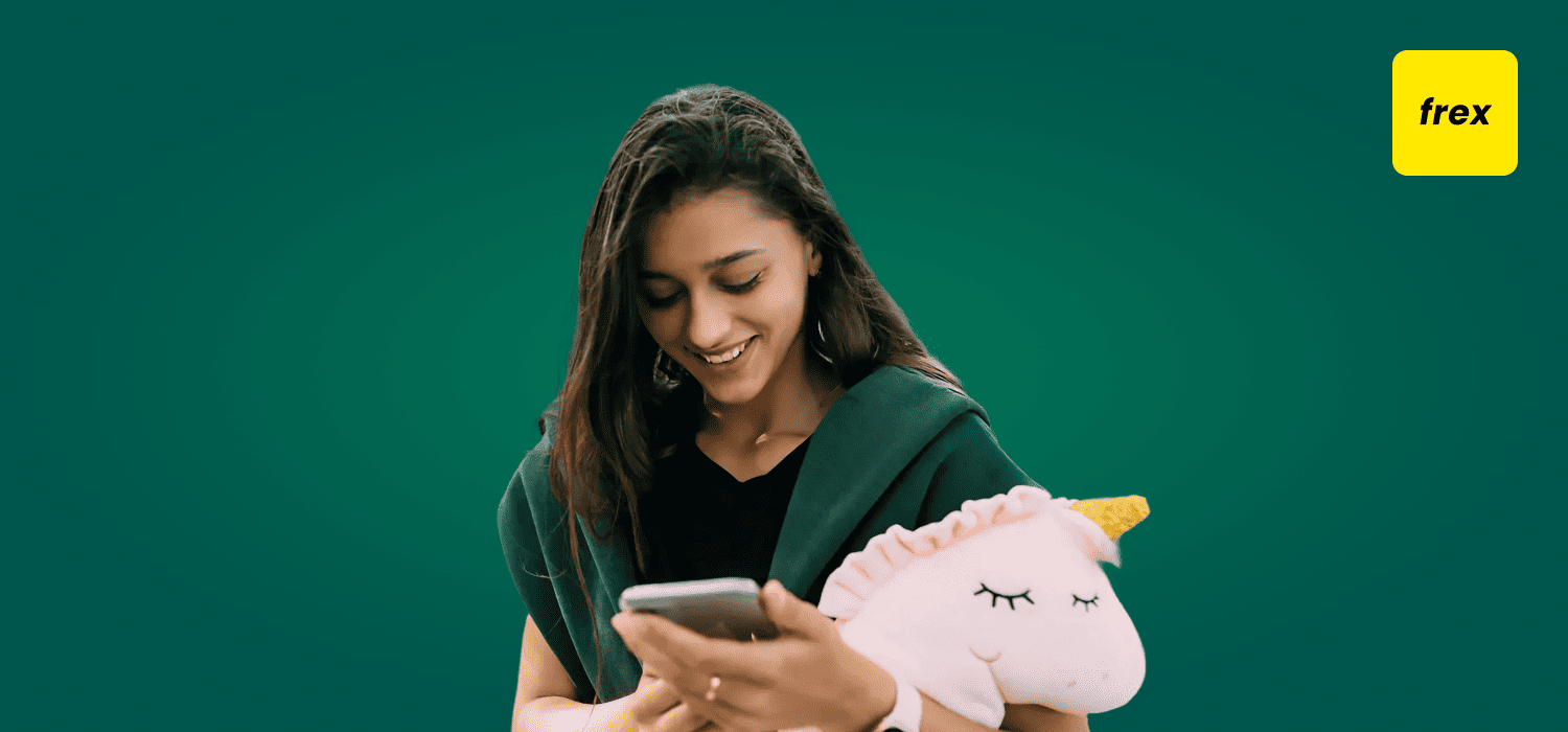 Girl holding her phone with a unicorn