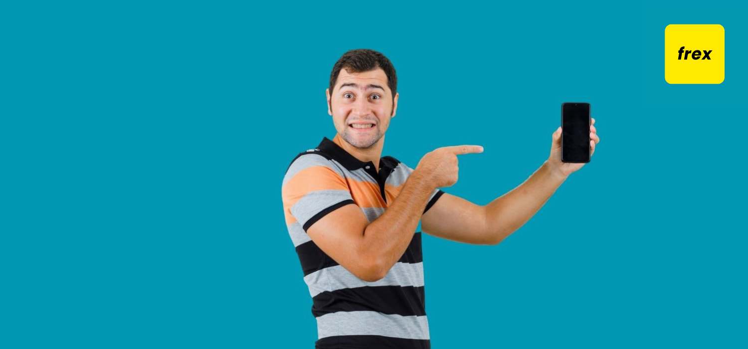 Young man pointing at phone