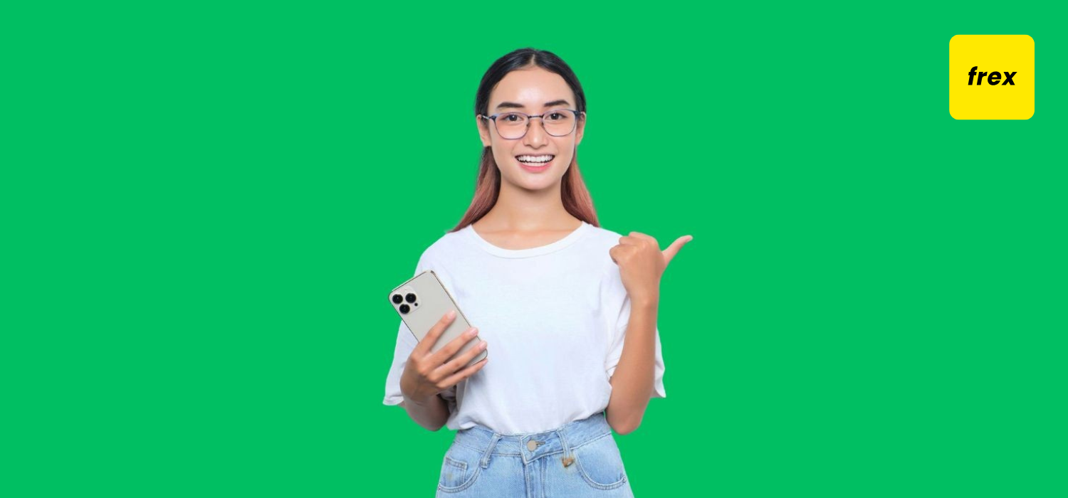 Portrait of cheerful young asian girl in white tshirt holding mobile phone